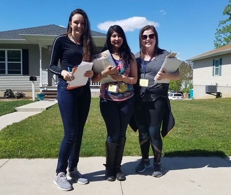 Three ISRC student employees conduct a door-to-door survey