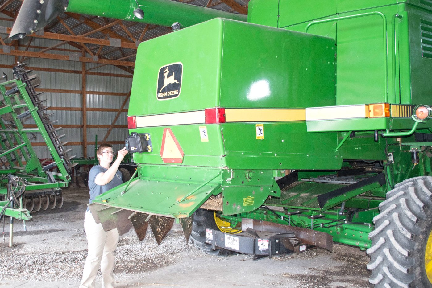 Michelle Reyes inspects instrumentation installed on a combine