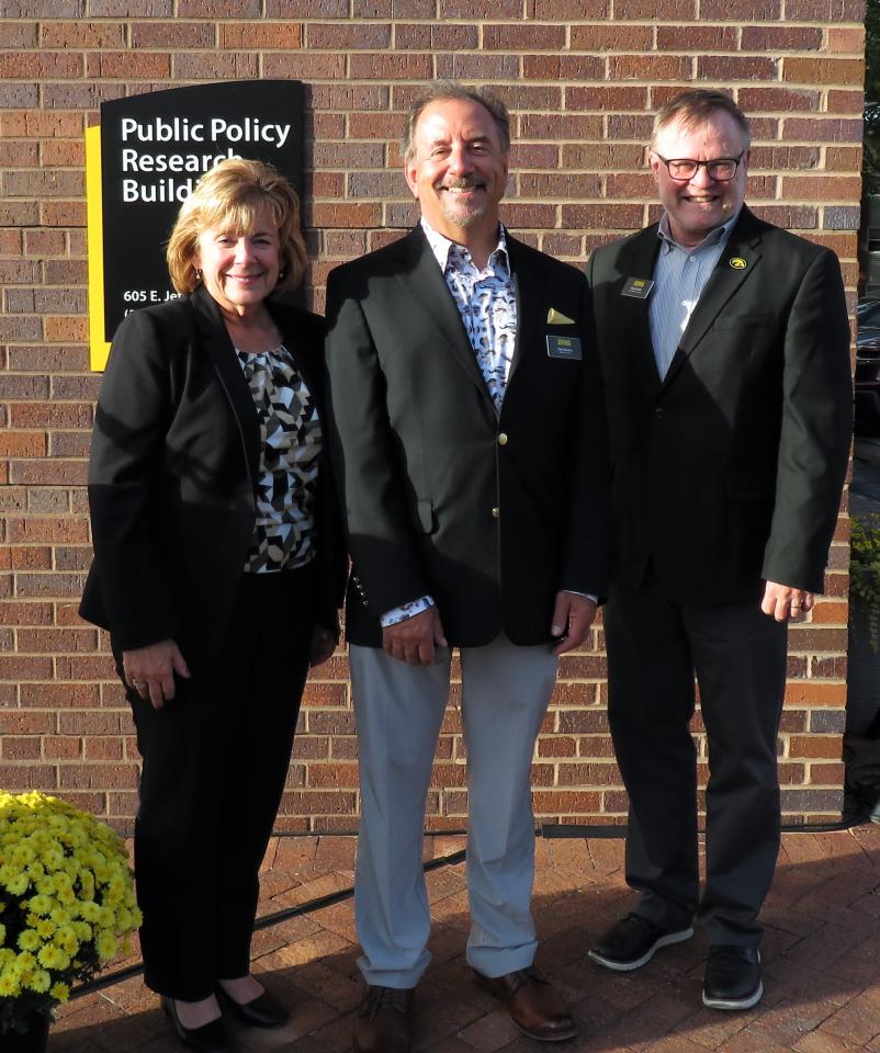 UI President Barbara Wilson, PPC Director Pete Damiano, and VPR Marty Scholtz pose in front of the Public Policy Research Building 