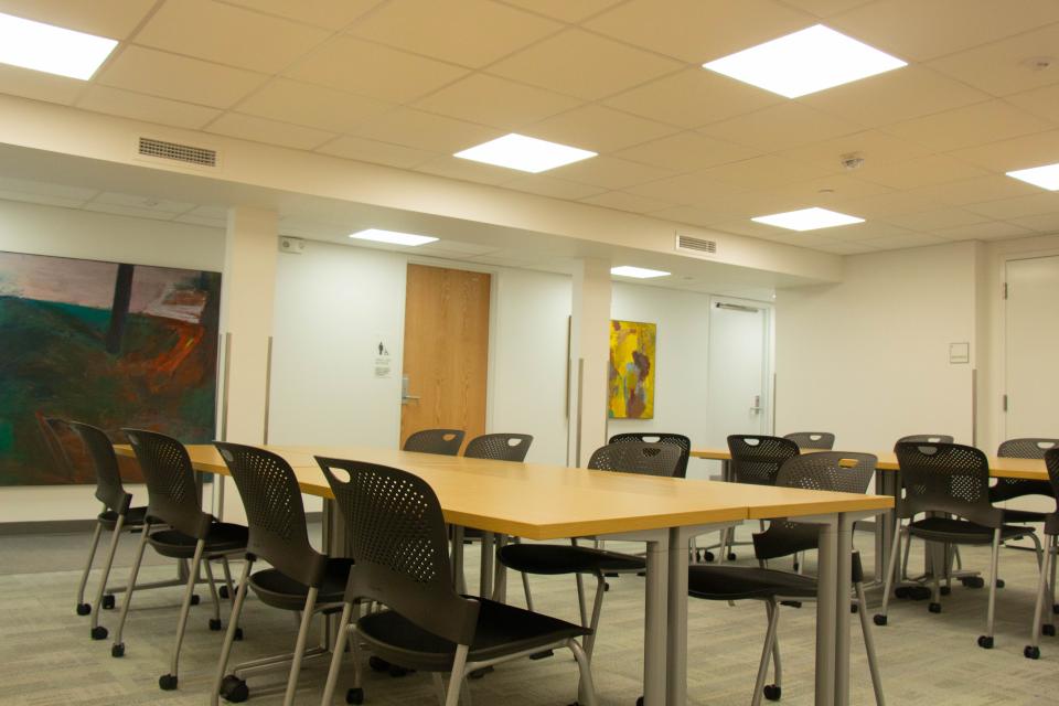 open classroom style meeting space with multiple tables and chairs around them
