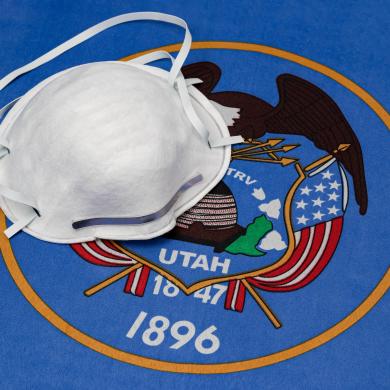 a Utah state flag with a mask on top of it
